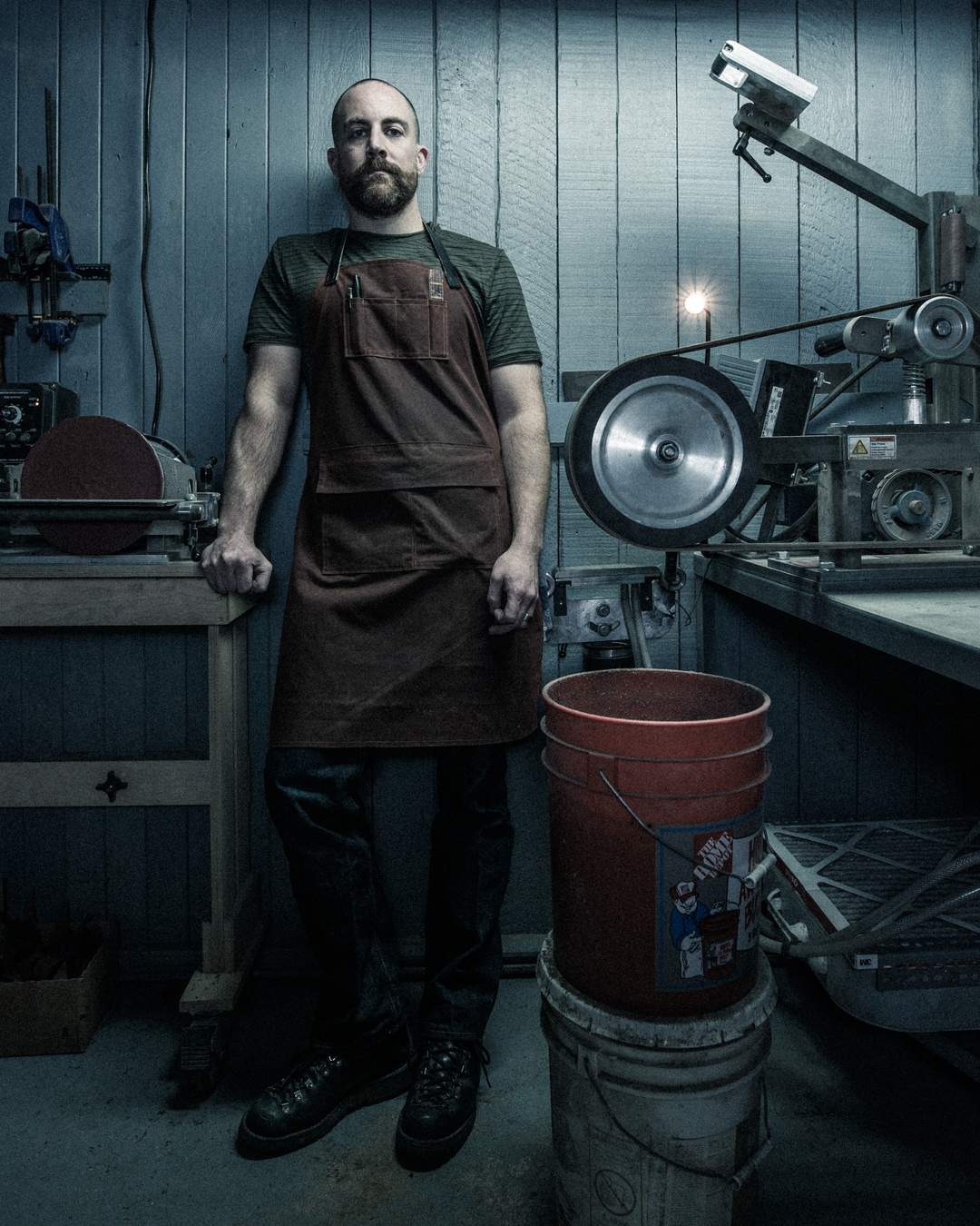Justin Leach standing by belt sander.